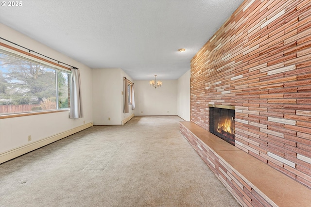 unfurnished living room with a fireplace, a textured ceiling, carpet flooring, baseboard heating, and a chandelier