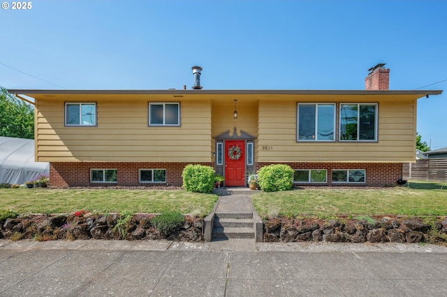 3511 NE Holman St, Portland, OR 97211 - bi-level home with a front lawn and a chimney