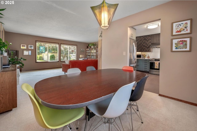3511 NE Holman St, Portland, OR 97211 - dining room featuring light colored carpet and baseboards