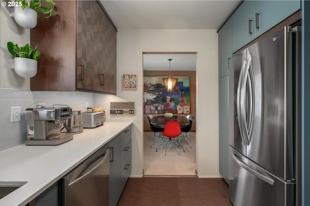 3511 NE Holman St, Portland, OR 97211 - kitchen featuring stainless steel appliances, light countertops, decorative backsplash, and dark carpet