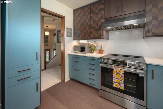 3511 NE Holman St, Portland, OR 97211 - kitchen with stainless steel appliances, range hood, carpet floors, and tasteful backsplash