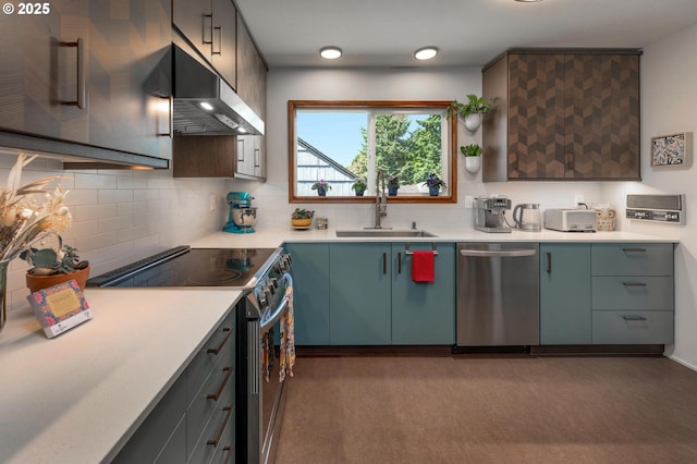 3511 NE Holman St, Portland, OR 97211 - kitchen featuring stainless steel appliances, exhaust hood, tasteful backsplash, and light countertops
