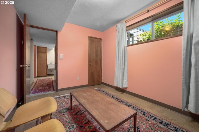 3511 NE Holman St, Portland, OR 97211 - living room featuring baseboards and a textured ceiling