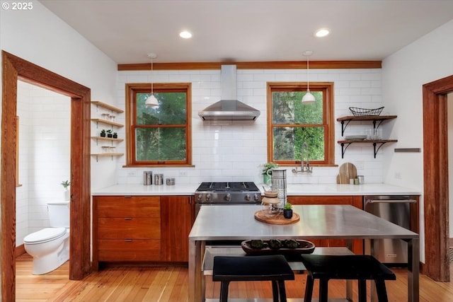 714 SE 35th Ave, Portland, OR 97214 - kitchen featuring wall chimney exhaust hood, open shelves, brown cabinets, light countertops, and recessed lighting