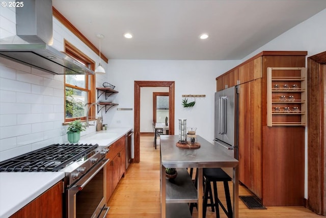 714 SE 35th Ave, Portland, OR 97214 - kitchen featuring stainless steel appliances, wall chimney exhaust hood, open shelves, light wood-type flooring, and recessed lighting