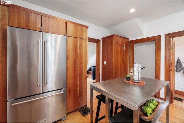 714 SE 35th Ave, Portland, OR 97214 - kitchen featuring high end fridge, light wood-style floors, lofted ceiling, brown cabinetry, and recessed lighting