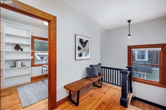 714 SE 35th Ave, Portland, OR 97214 - hall with light wood-style flooring, an upstairs landing, and baseboards