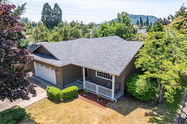 576 S 35th St, Springfield, OR 97478 - view of front facade featuring roof with shingles, a porch, an attached garage, concrete driveway, and a front yard