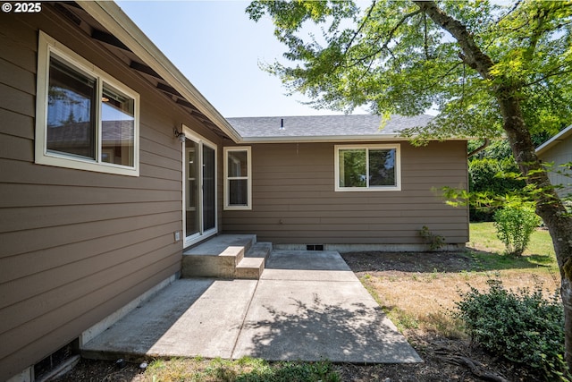 576 S 35th St, Springfield, OR 97478 - view of exterior entry featuring a patio area, crawl space, and a shingled roof