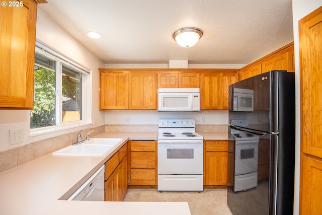 576 S 35th St, Springfield, OR 97478 - kitchen featuring white appliances, light countertops, and brown cabinets