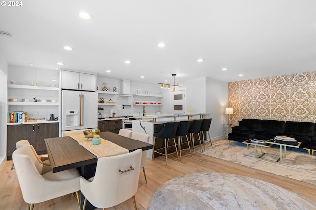 dining room featuring light hardwood / wood-style flooring and sink