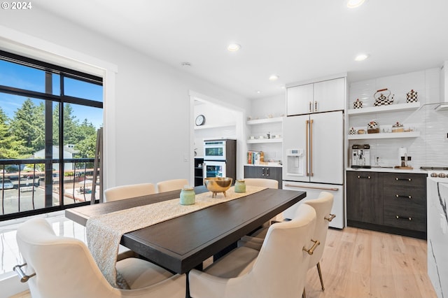 dining space with light hardwood / wood-style floors