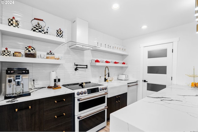 kitchen with dishwasher, light stone countertops, high end stove, dark brown cabinetry, and island exhaust hood