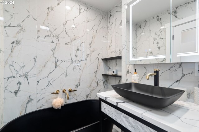 bathroom with vanity and tile walls