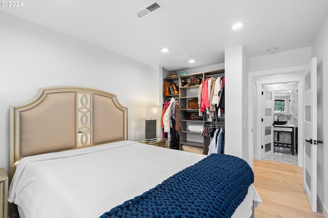 bedroom with hardwood / wood-style flooring and a closet