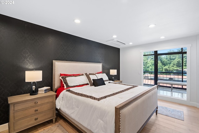 bedroom featuring access to exterior and light hardwood / wood-style floors