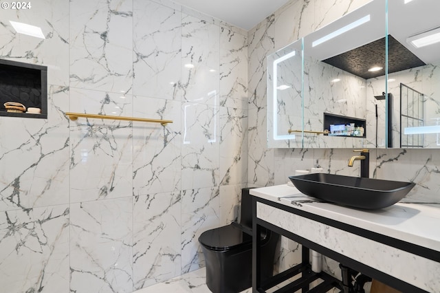 bathroom with vanity, toilet, walk in shower, and tile walls