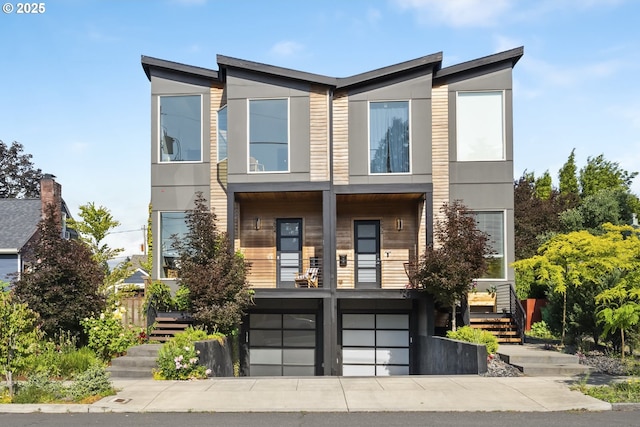 5674 NE 15th Ave, Portland, OR 97211 - contemporary house featuring stairs, a garage, and stucco siding