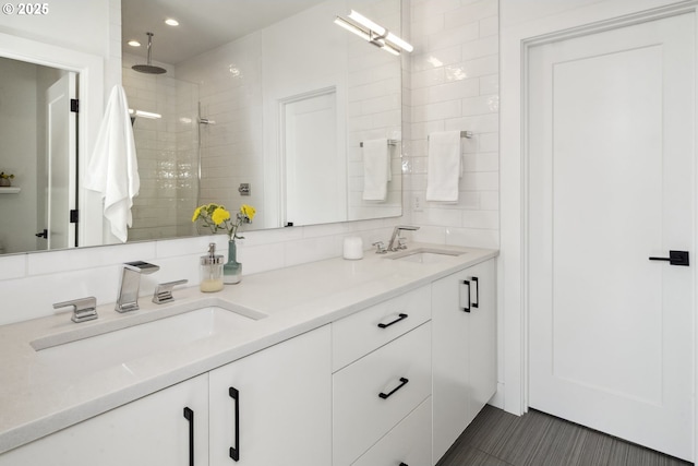 5674 NE 15th Ave, Portland, OR 97211 - bathroom with double vanity, a tile shower, recessed lighting, and decorative backsplash