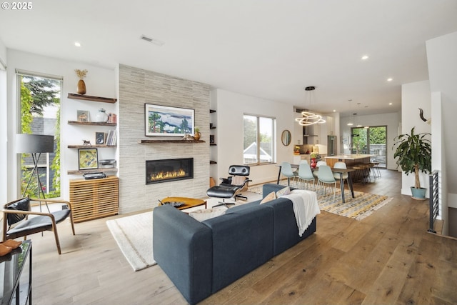 5674 NE 15th Ave, Portland, OR 97211 - living room featuring a tile fireplace, hardwood / wood-style floors, plenty of natural light, and recessed lighting