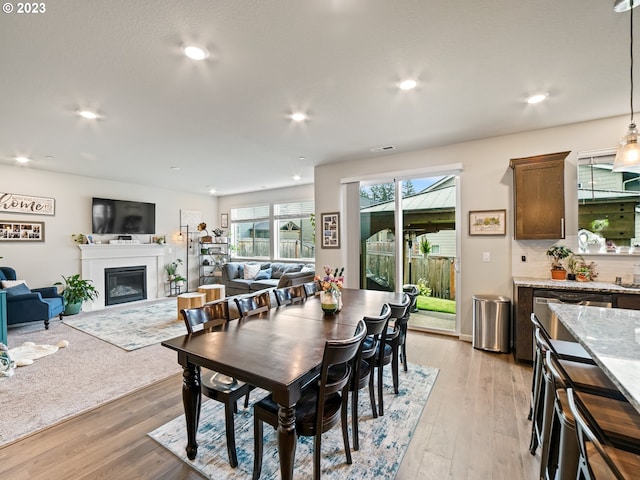 6212 N 87th Ave, Camas, WA 98607 - dining room with light wood-style floors, a glass covered fireplace, and recessed lighting