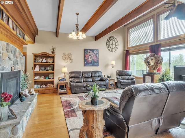7145 SE Amity Dayton Hwy, Amity, OR 97101 - living area with a stone fireplace, a chandelier, light wood finished floors, and beam ceiling
