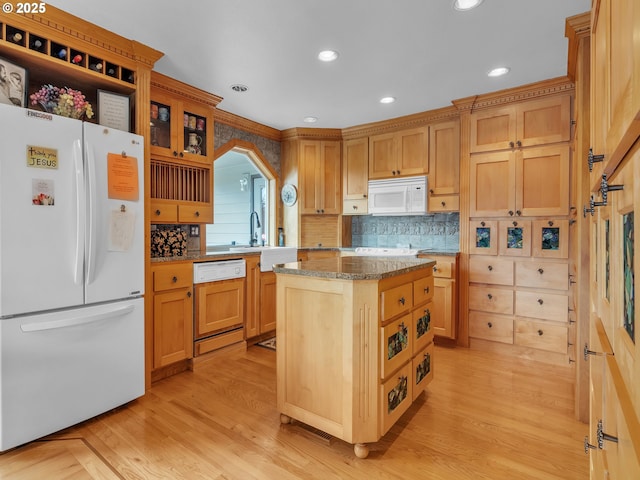7145 SE Amity Dayton Hwy, Amity, OR 97101 - kitchen with white appliances, a kitchen island, tasteful backsplash, light wood finished floors, and a sink
