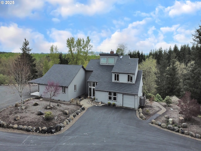 7145 SE Amity Dayton Hwy, Amity, OR 97101 - view of front of property featuring driveway, a chimney, roof with shingles, and a garage
