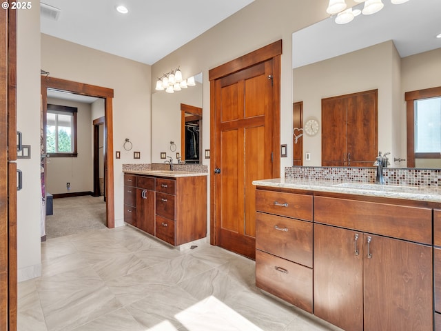 7145 SE Amity Dayton Hwy, Amity, OR 97101 - full bath featuring decorative backsplash, two vanities, baseboards, and a spacious closet