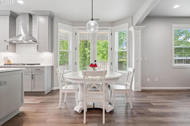 dining area featuring light wood-style floors, baseboards, recessed lighting, and a wealth of natural light