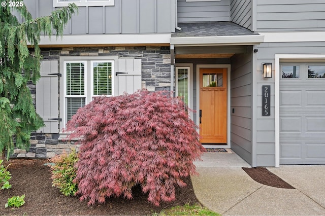 view of exterior entry featuring board and batten siding and stone siding
