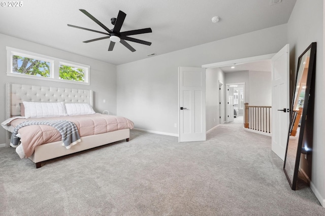 carpeted bedroom with baseboards, a ceiling fan, and visible vents