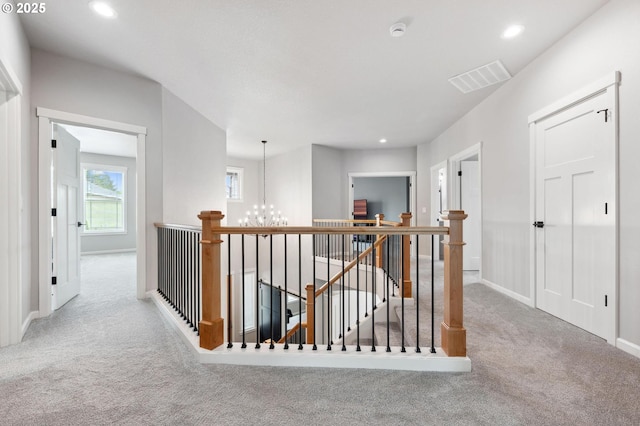 hall featuring a notable chandelier, carpet floors, recessed lighting, an upstairs landing, and visible vents