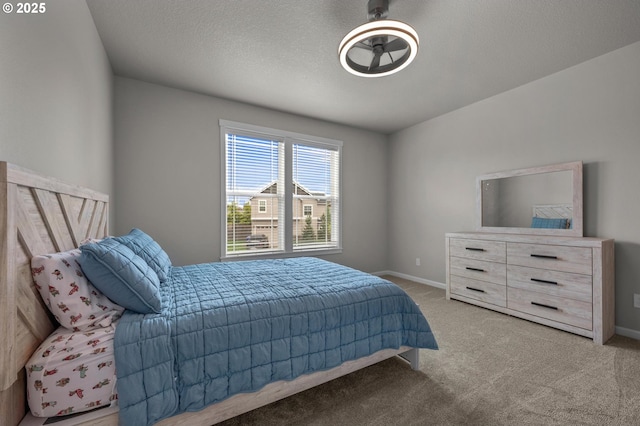 carpeted bedroom featuring baseboards