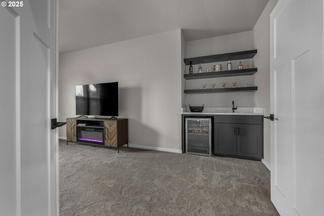bar featuring a sink, carpet floors, wet bar, baseboards, and wine cooler