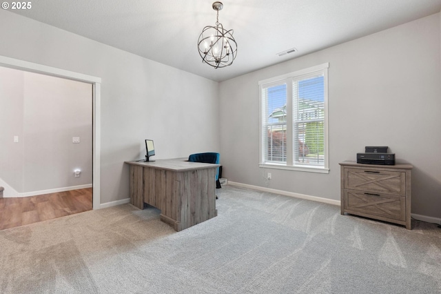 office featuring visible vents, baseboards, light carpet, and an inviting chandelier