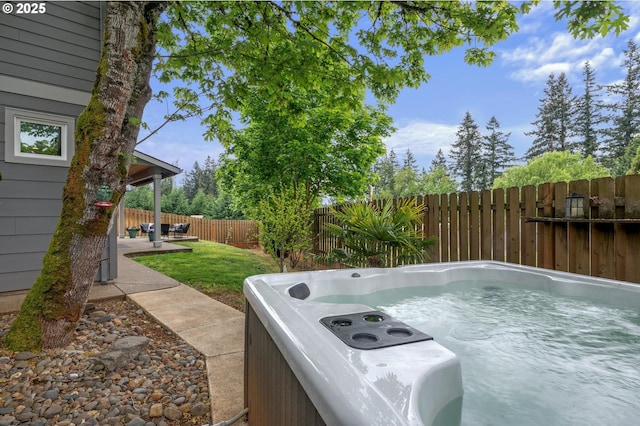 view of yard with a patio, a fenced backyard, and a hot tub