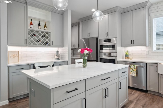 kitchen featuring a kitchen island, gray cabinetry, and stainless steel appliances