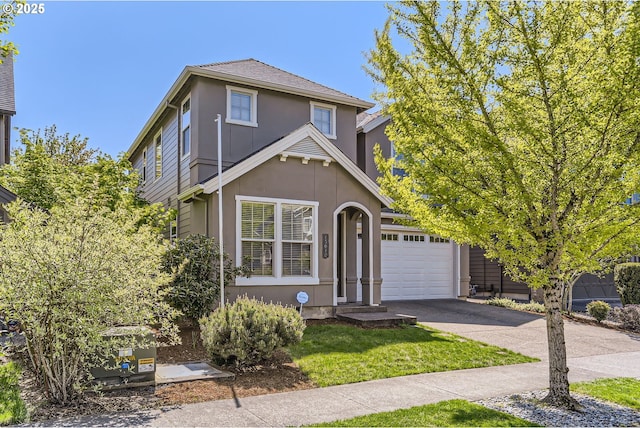 15610 SE Kingbird Dr, Happy Valley, OR 97015 - traditional-style house featuring an attached garage, asphalt driveway, stucco siding, and a front lawn