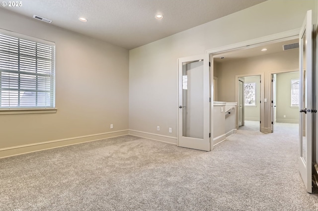 15610 SE Kingbird Dr, Happy Valley, OR 97015 - empty room with light carpet, recessed lighting, baseboards, and a textured ceiling