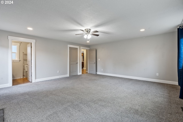 unfurnished bedroom featuring ceiling fan, ensuite bathroom, a textured ceiling, and carpet