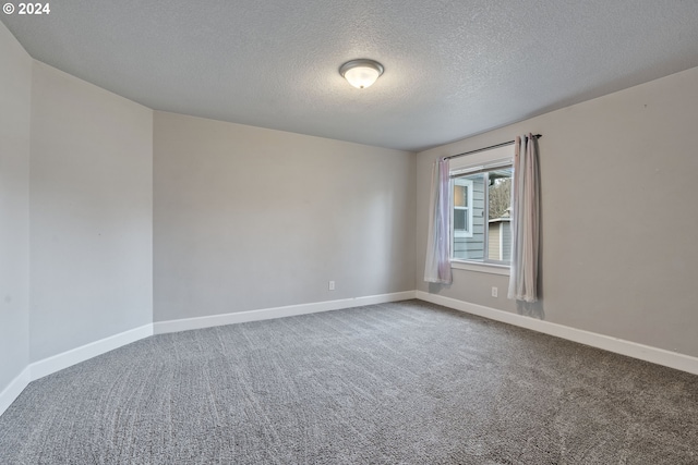 carpeted spare room with a textured ceiling