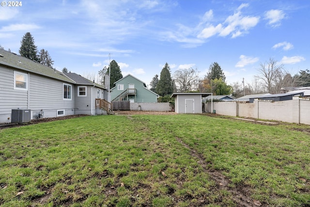 view of yard with a storage shed and central air condition unit