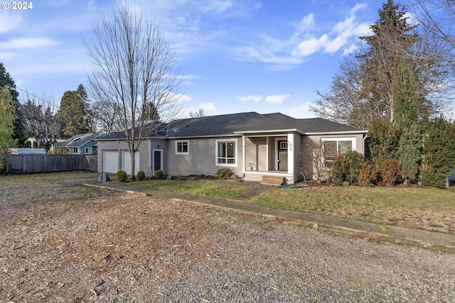 ranch-style house with a garage and a front lawn