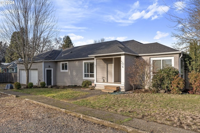 view of front of property featuring a garage and a front lawn