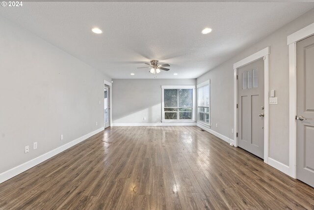 interior space with ceiling fan, a textured ceiling, and dark hardwood / wood-style flooring