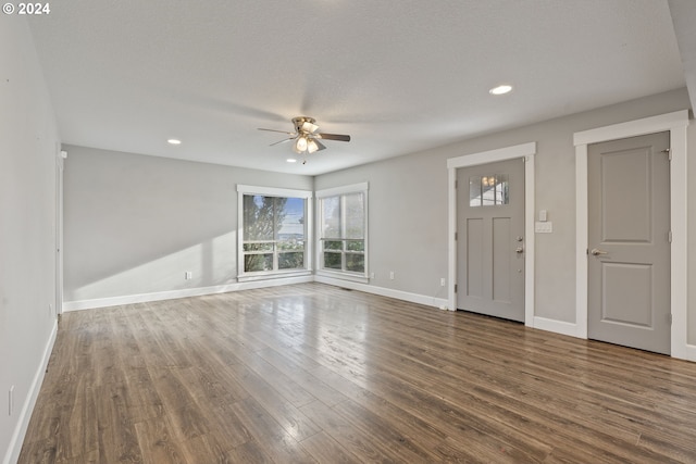 foyer entrance featuring dark wood-type flooring, a textured ceiling, and ceiling fan