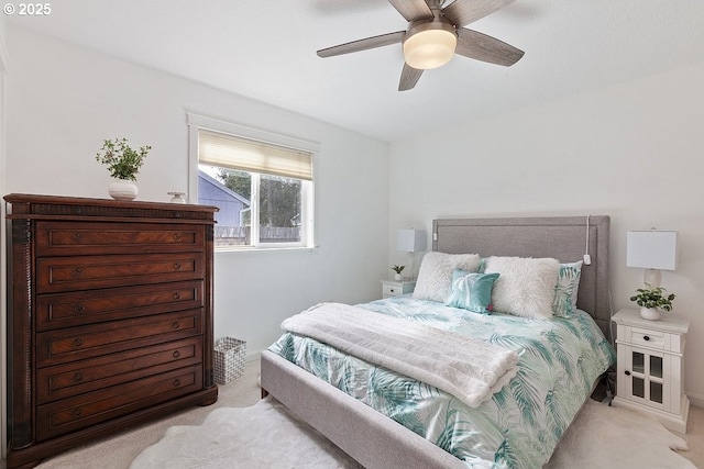 bedroom with ceiling fan and light colored carpet