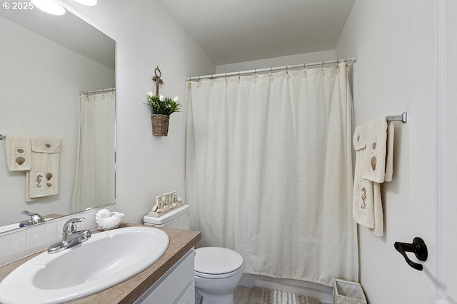 full bath featuring vanity and toilet