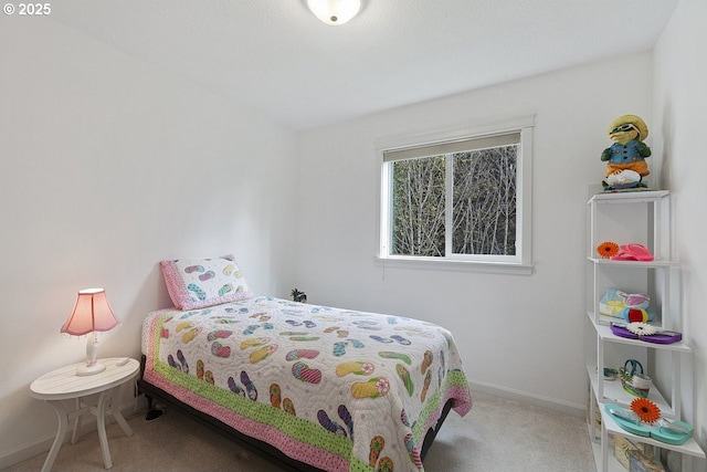 bedroom featuring carpet and baseboards